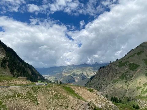 Mountain Pass Road Under Dramatic Cloudy Sky Stock Photos