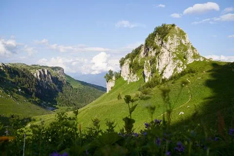 A mountain pass surrounded by rocks and shadows from the setting sun. Stock Photos