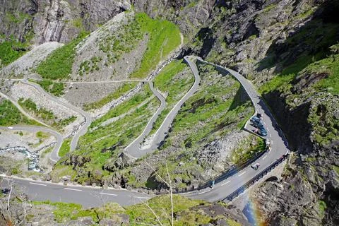 Mountain pass in zig zag narrow switchbacks barren mountains rainbow narrow Stock Photos