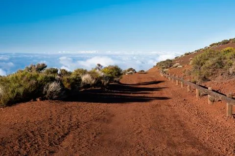 Mountain path above the clouds Stock Photos
