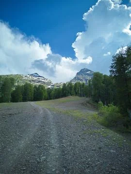 Mountain path under the clouds Stock Photos
