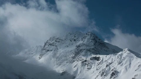 Mountain peack misty cloud covered. Winter season Alps Stock-Footage 88044333