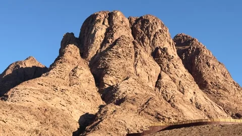 Mountain peak above small Bedouin stone house in desert valley. Telephoto lens 스톡 동영상 341452062