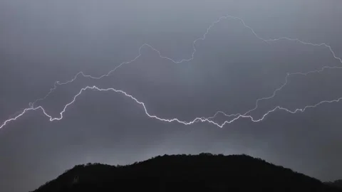 Mountain Peak and Thunder Bolt Against Storm Clouds Видео 272762422