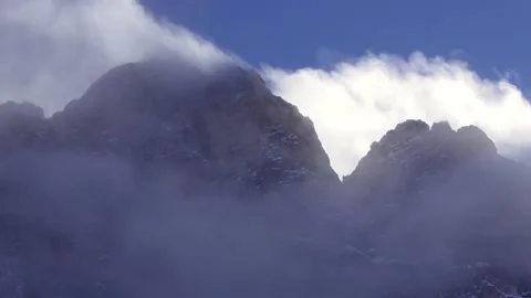 Mountain peak with clouds and wind with clear sky. Foggy mountains. Alps 스톡 동영상 230629227