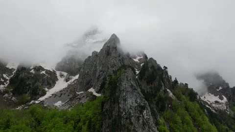 Mountain peak in the clouds, evening mystery light. Stock Footage 249999384