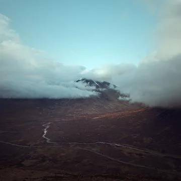 Mountain peak covered with clouds Stock Photos