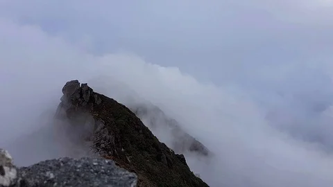 Mountain peak covered by intense fog time lapse Stock Footage 111137293