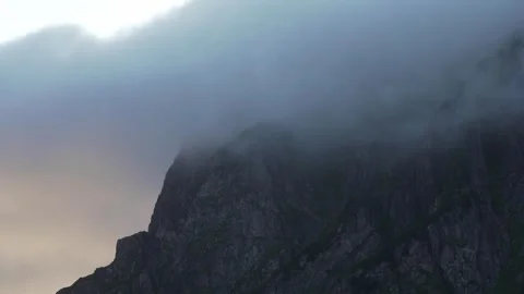 Mountain peak covered in mist at dawn Stock Footage 243889183