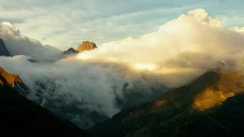 Mountain Peak Covered in Morning Clouds – Serene Aerial Nature Footage Stock Footage 310533581