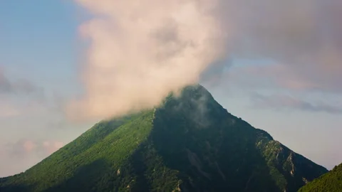 Mountain Peak Covered by Passing Clouds – 4K 30fps Stock Footage 322211668