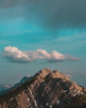 Mountain peak with dark cloud above 库存照片