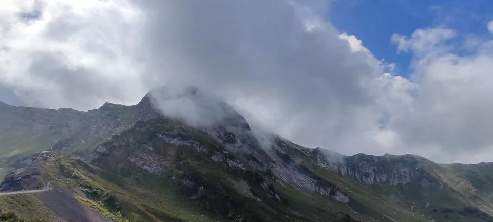 Mountain peak enveloped in clouds, creating majestic atmosphere for adventu.. Stock Photos