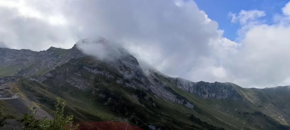Mountain peak enveloped in clouds, creating majestic atmosphere for adventu.. Stock Photos