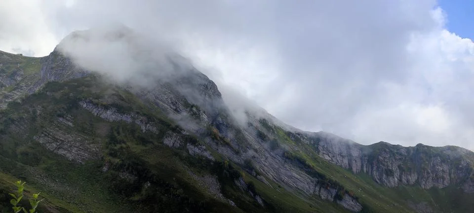 Mountain peak enveloped in clouds, creating majestic atmosphere for adventu.. Stock Photos