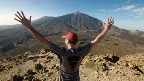 Mountain Peak. Man Standing and Raising His Hands Stock Footage 77567446