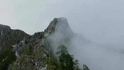 Mountain peak opening view through clouds, from drone. Stock Footage 249999766