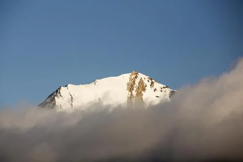 A mountain peak, peeping through the cloud at Bourbonhamna 77 33n 15 00e Spit Stock Photos