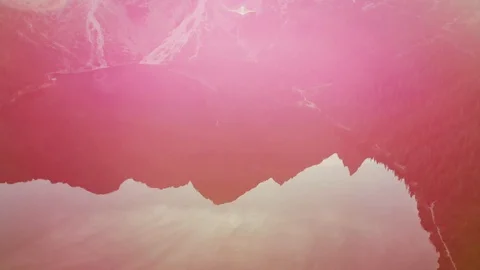 Mountain peak reflection in the lake water at sunset. Sunlight and lens flares. Stock Footage 120555485