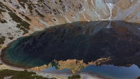 Mountain peak reflection in lake water at sunrise. Alpine lake in the morning. Stock-Footage 120582024