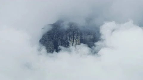 Mountain peak shrouded in clouds Stock Footage 219715939
