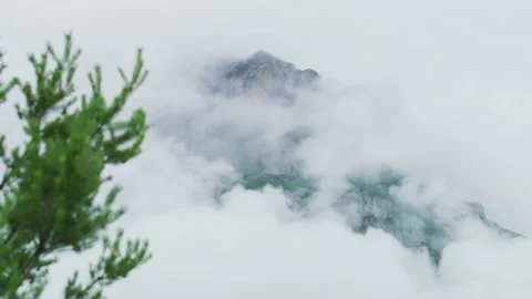 Mountain peak shrouded in clouds Stock Footage 219722473