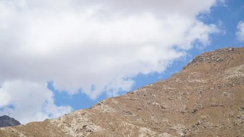 Mountain peak with some clouds and clear blue sky Foto stock