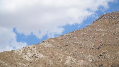 Mountain peak with some clouds and clear blue sky Foto stock