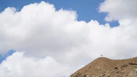 Mountain peak with some clouds and clear blue sky Stock Photos