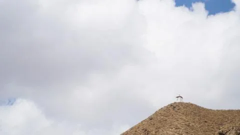 Mountain peak with some clouds and clear blue sky Stock Photos