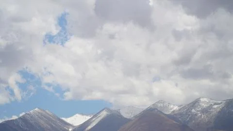Mountain peak with some clouds and clear blue sky Foto stock