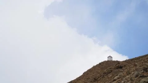 Mountain peak with some clouds and clear blue sky Stock Photos