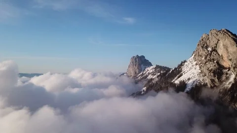 Mountain peaks above clouds in Alps, aerial 4k footage by drone Stock Footage 119987614