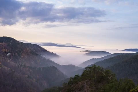 Mountain peaks above clouds Stock Photos