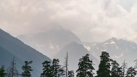 Mountain peaks against the background of fast-moving clouds. Stock Footage 158012372