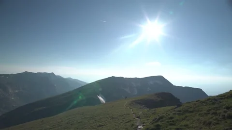 Mountain Peaks and Sun Handheld 4K Stock Footage 65290796