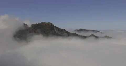 Mountain peaks in the clouds and birds in flight, 4K Stock Footage 246388818