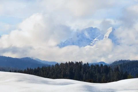 Mountain peaks in clouds during winter Stock Photos