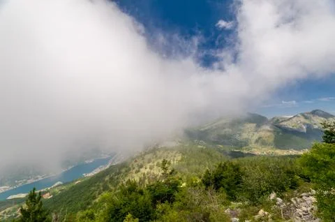 Mountain peaks in clouds Stock Photos