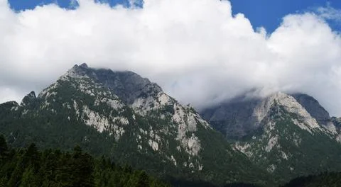Mountain peaks covered by clouds Stock Photos