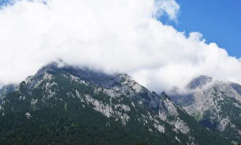 Mountain peaks covered by clouds Stock Photos