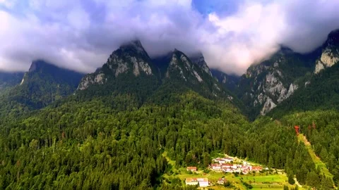 Mountain peaks hidden behind dense clouds above green forest Stock-Footage 341329617