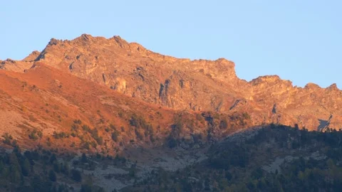 Mountain peaks illuminated by the setting sun. Stock Footage 166906045
