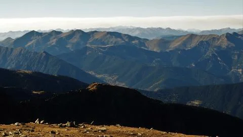 Mountain peaks layering under clear sky Stock Photos
