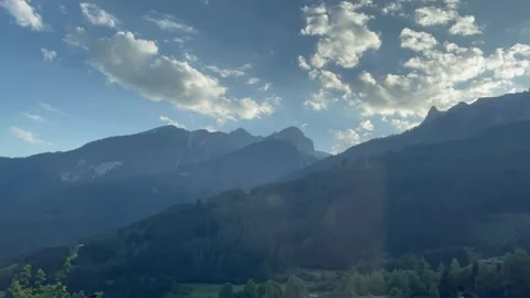 Mountain Peaks with Moving Clouds Under Blue Sky Stock Footage 340164462
