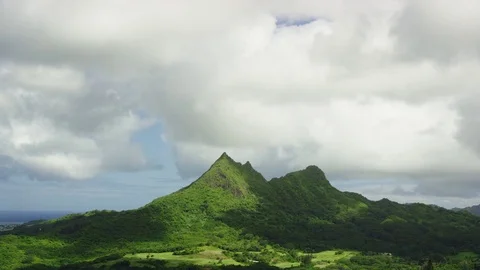 Mountain peaks, ocean, moving clouds, tropical valley below, plate Stock Footage 80508532