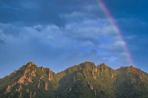 Mountain Peaks with Rainbow in Dramatic Sky Stock Photos