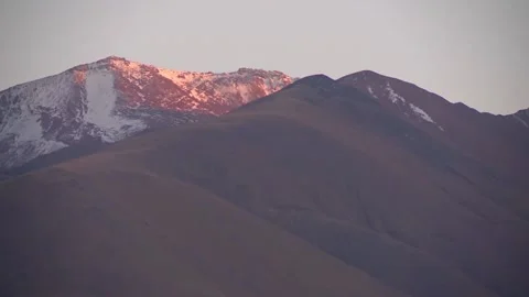 Mountain peaks in the snow, the setting sun, the greatness of the mountains Stock Footage 98124509