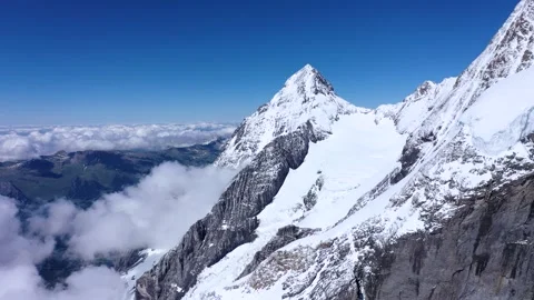 Mountain peaks Towering above clouds Stock Footage 247797326
