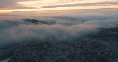 A mountain peeking through the wintery clouds Stock Footage 89652092